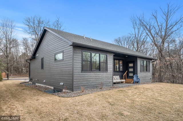 view of front facade with roof with shingles, a front yard, and entry steps