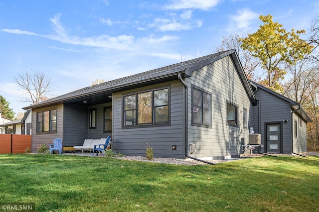 rear view of property with a yard