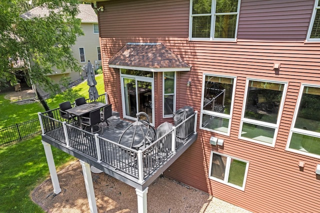 17397 73rd Pl N, Maple Grove, MN 55311 - back of property with a wooden deck, outdoor dining area, and roof with shingles