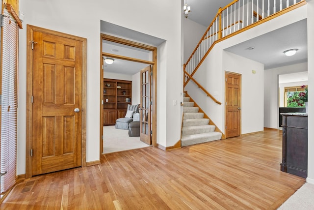 17397 73rd Pl N, Maple Grove, MN 55311 - entrance foyer with light wood-style floors, stairway, and a high ceiling