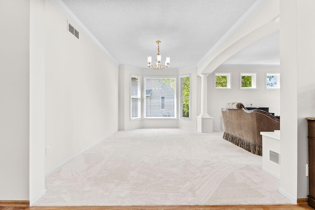 17397 73rd Pl N, Maple Grove, MN 55311 - entryway with crown molding, decorative columns, a chandelier, carpet, and a textured ceiling