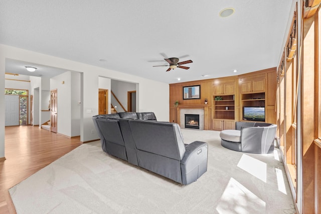 17397 73rd Pl N, Maple Grove, MN 55311 - living area featuring light carpet, a glass covered fireplace, ceiling fan, light wood-style floors, and recessed lighting