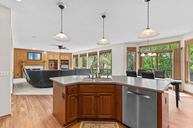 17397 73rd Pl N, Maple Grove, MN 55311 - kitchen featuring stainless steel dishwasher, a textured ceiling, light wood-type flooring, open floor plan, and decorative light fixtures