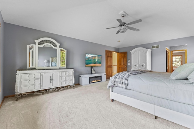 17397 73rd Pl N, Maple Grove, MN 55311 - bedroom featuring light carpet, lofted ceiling, a glass covered fireplace, and ceiling fan