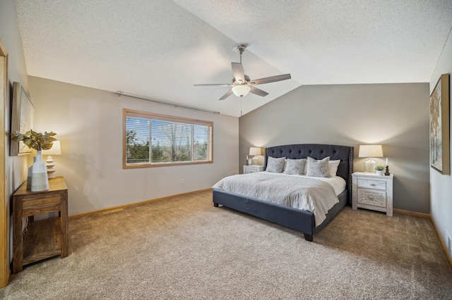 carpeted bedroom with baseboards, a textured ceiling, ceiling fan, and vaulted ceiling