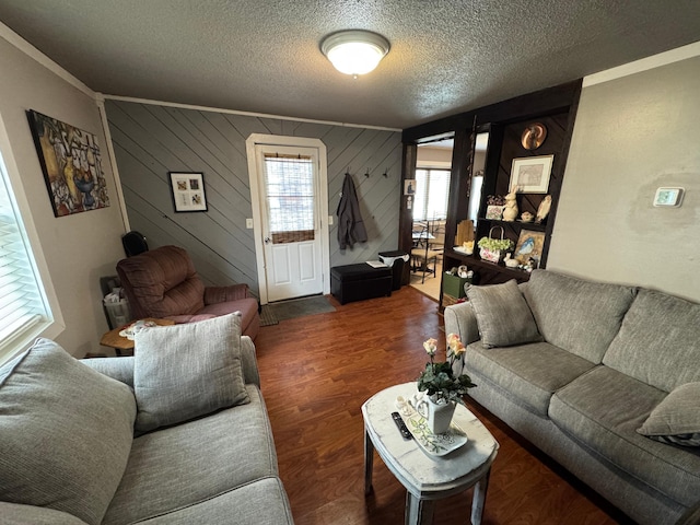 living area with a textured ceiling and wood finished floors