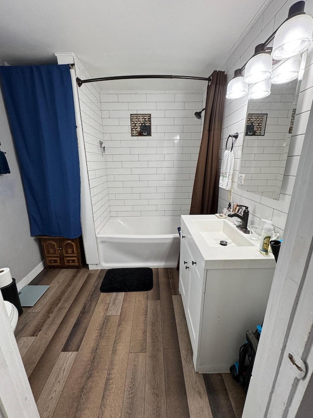 bathroom with vanity, tile walls, wood finished floors, and shower / tub combo with curtain