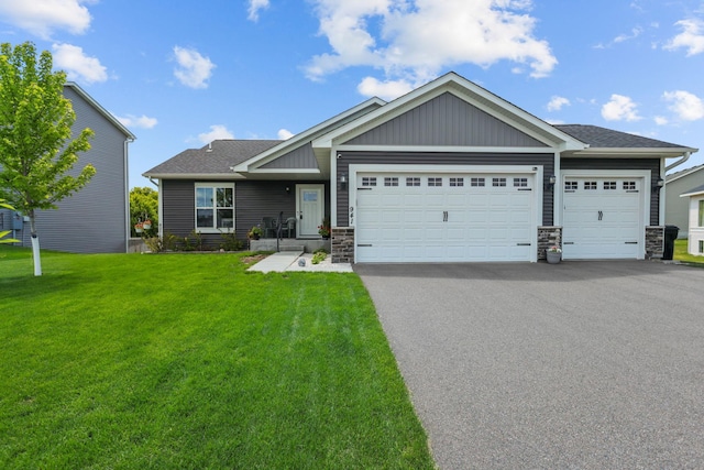 941 Whiskey Rd NW, Isanti, MN 55040 - craftsman-style home featuring an attached garage, driveway, stone siding, and a front lawn