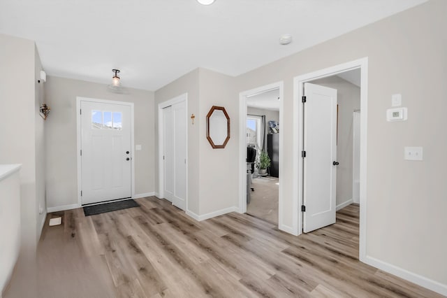 941 Whiskey Rd NW, Isanti, MN 55040 - foyer entrance featuring light wood-style floors and baseboards