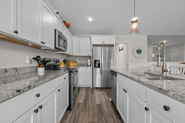941 Whiskey Rd NW, Isanti, MN 55040 - kitchen featuring stainless steel appliances, a sink, white cabinetry, dark wood-style floors, and pendant lighting