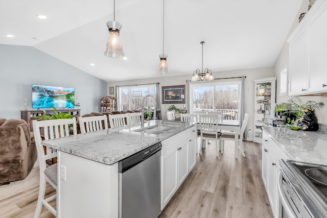 941 Whiskey Rd NW, Isanti, MN 55040 - kitchen featuring appliances with stainless steel finishes, lofted ceiling, light wood finished floors, a breakfast bar area, and open floor plan