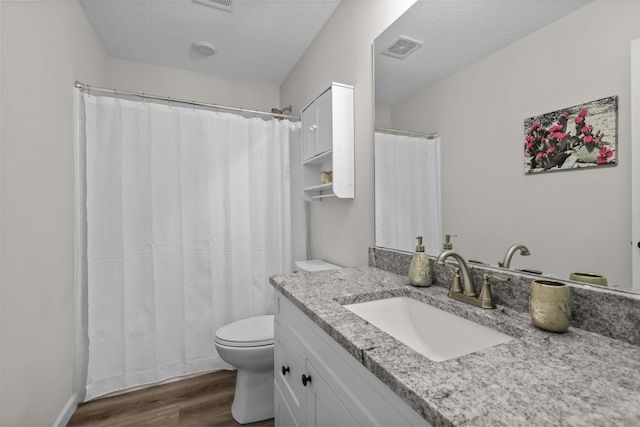 941 Whiskey Rd NW, Isanti, MN 55040 - full bath with wood finished floors, toilet, vanity, and a shower with shower curtain