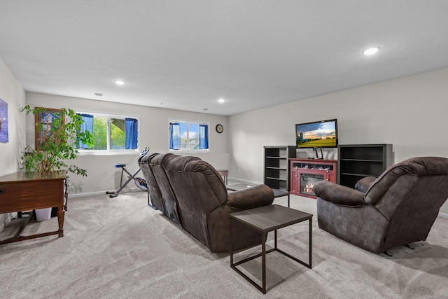 941 Whiskey Rd NW, Isanti, MN 55040 - living room featuring light colored carpet, baseboards, recessed lighting, and a glass covered fireplace