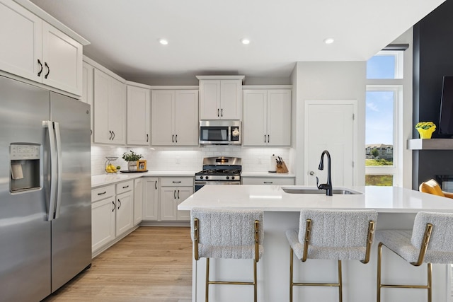 6767 Bluestem Way, Minnetrista, MN 55331 - kitchen with stainless steel appliances, plenty of natural light, tasteful backsplash, light countertops, and recessed lighting