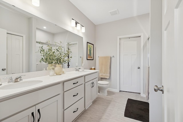 6767 Bluestem Way, Minnetrista, MN 55331 - bathroom featuring double vanity and toilet
