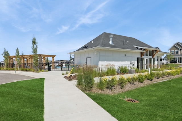 6767 Bluestem Way, Minnetrista, MN 55331 - view of side of property with a pergola, board and batten siding, and a shingled roof