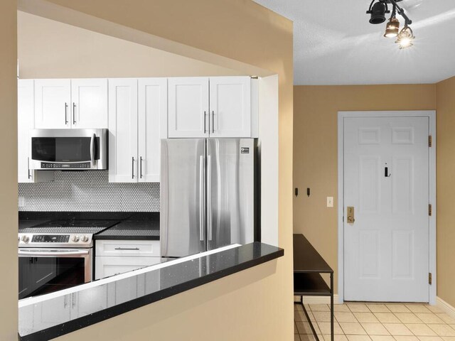 7605 Edinborough Way Unit 6314, Edina, MN 55435 - kitchen featuring dark countertops, appliances with stainless steel finishes, white cabinets, and decorative backsplash