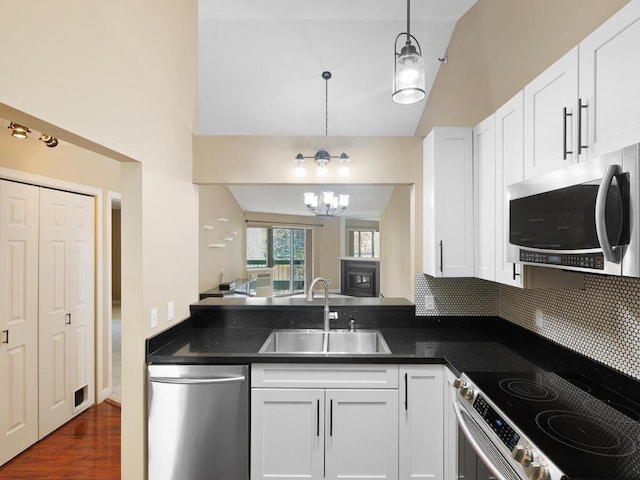 7605 Edinborough Way Unit 6314, Edina, MN 55435 - kitchen featuring an inviting chandelier, high vaulted ceiling, white cabinetry, a sink, and appliances with stainless steel finishes