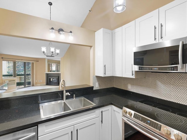 7605 Edinborough Way Unit 6314, Edina, MN 55435 - kitchen featuring lofted ceiling, white cabinets, a chandelier, a sink, and appliances with stainless steel finishes
