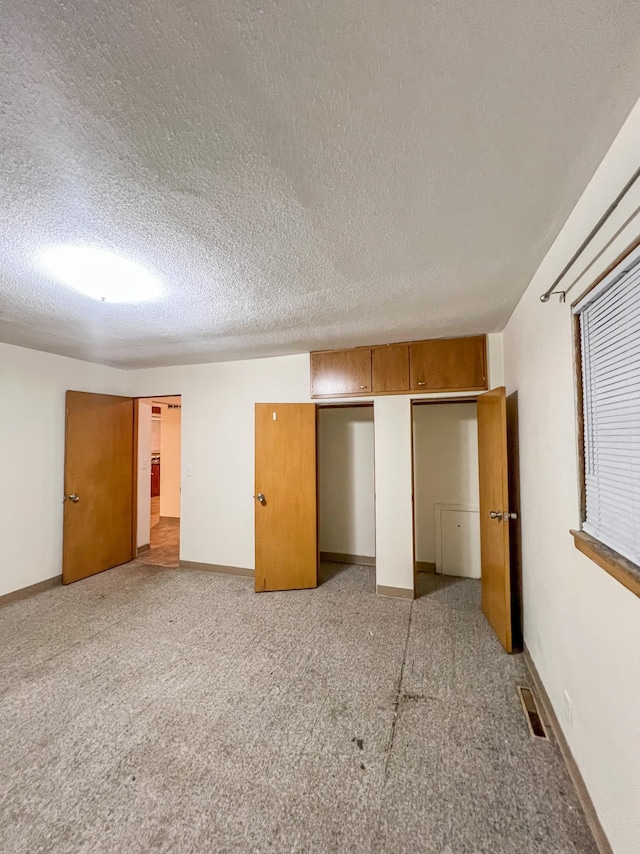 302 Elmwood St, Arlington, MN 55307 - unfurnished bedroom featuring a textured ceiling, light colored carpet, and baseboards