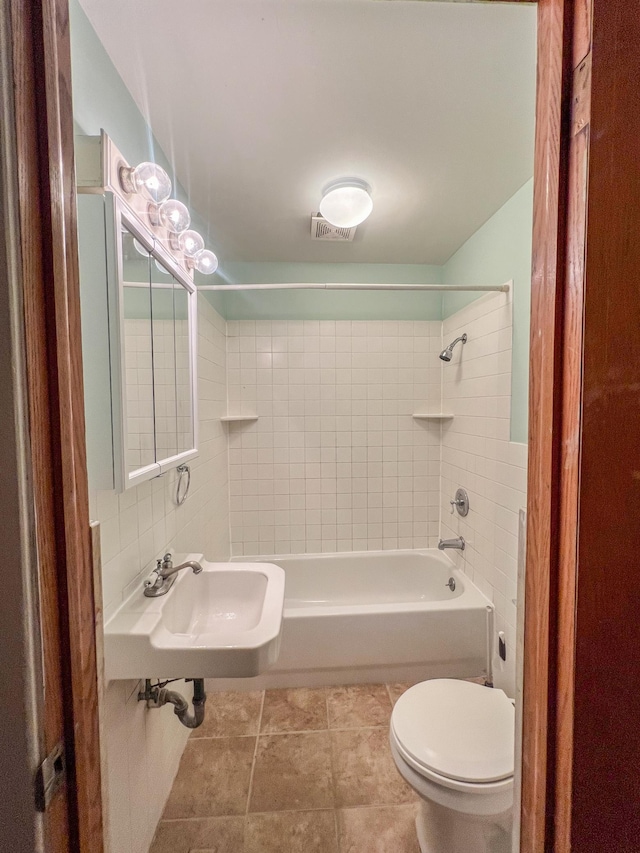 302 Elmwood St, Arlington, MN 55307 - bathroom with toilet, a sink, tub / shower combination, and tile patterned flooring