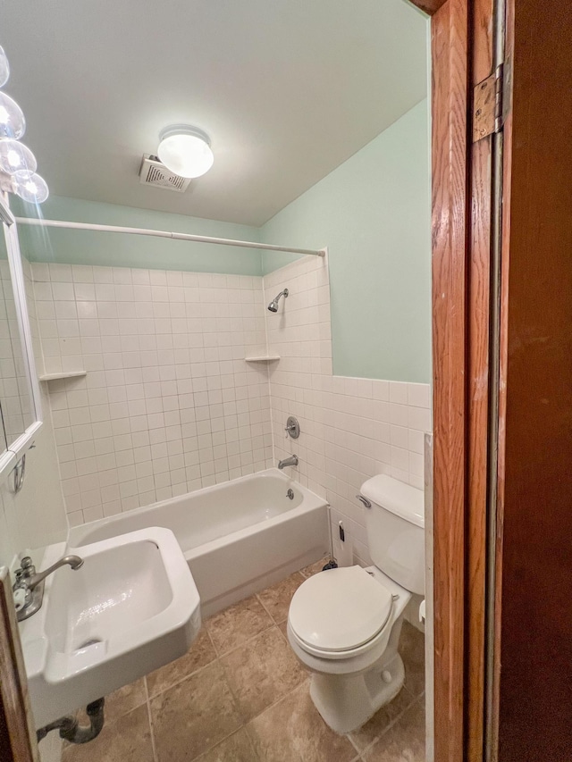 302 Elmwood St, Arlington, MN 55307 - bathroom with a sink, toilet, tile walls, bathtub / shower combination, and tile patterned floors