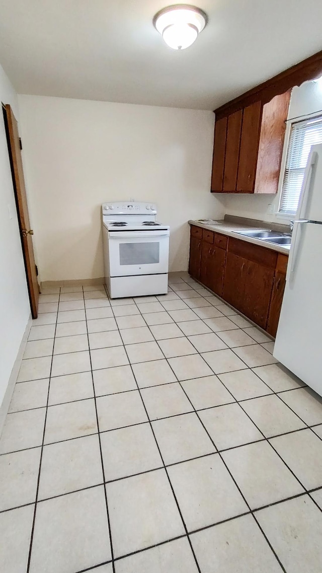 302 Elmwood St, Arlington, MN 55307 - kitchen featuring white appliances, a sink, light countertops, and light tile patterned flooring