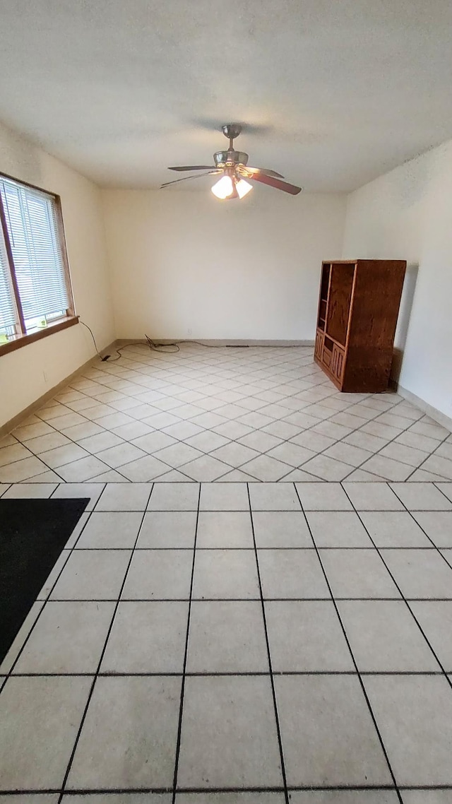 302 Elmwood St, Arlington, MN 55307 - unfurnished room featuring ceiling fan, baseboards, and light tile patterned floors