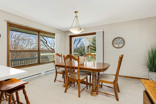 dining space with light colored carpet, a baseboard heating unit, and baseboards