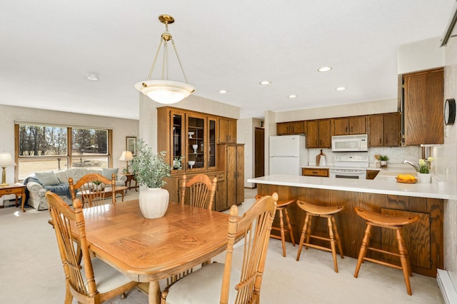 dining space with light colored carpet and recessed lighting