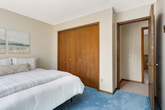 bedroom with light colored carpet, a closet, and baseboards
