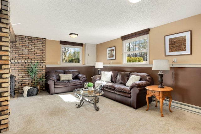 carpeted living room with a textured ceiling and a baseboard heating unit
