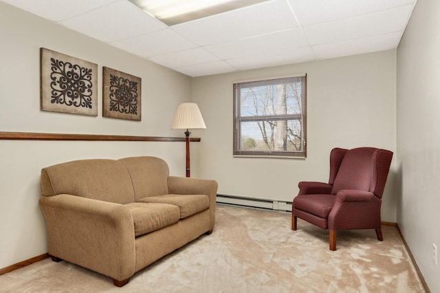 sitting room with a paneled ceiling, a baseboard radiator, carpet flooring, and baseboards