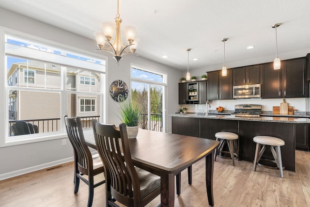 8945 Village Loop, Chanhassen, MN 55317 - dining room featuring light wood-type flooring, a chandelier, baseboards, and recessed lighting
