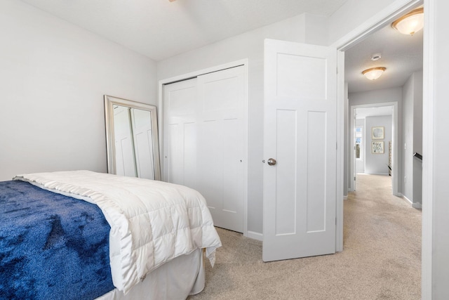 8945 Village Loop, Chanhassen, MN 55317 - bedroom with light colored carpet, a closet, and baseboards