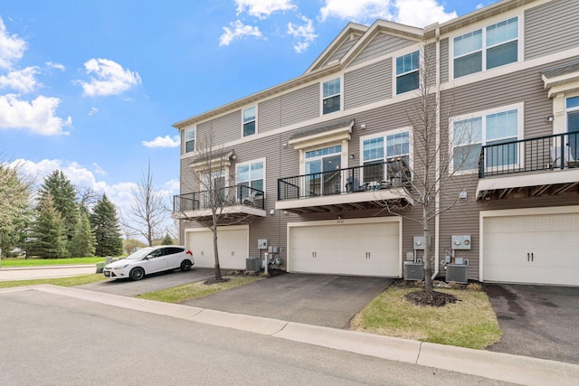8945 Village Loop, Chanhassen, MN 55317 - view of property with an attached garage, driveway, and central AC