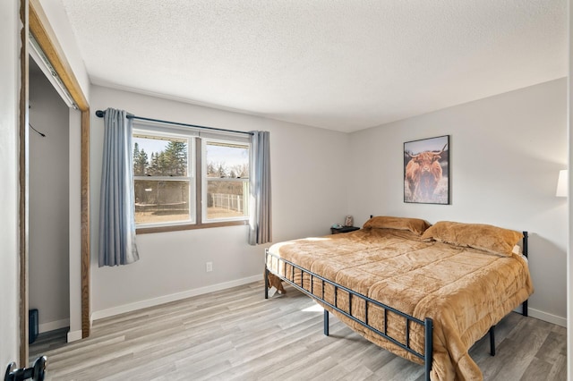 2510 152nd Ln NE, Ham Lake, MN 55304 - bedroom with a textured ceiling, light wood-type flooring, and baseboards