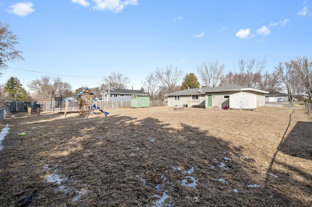 2510 152nd Ln NE, Ham Lake, MN 55304 - view of yard with a fenced backyard, a storage unit, a playground, and an outdoor structure