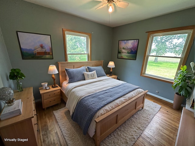 10855 150th St NE, Spicer, MN 56288 - bedroom with wood-type flooring, baseboards, and a ceiling fan