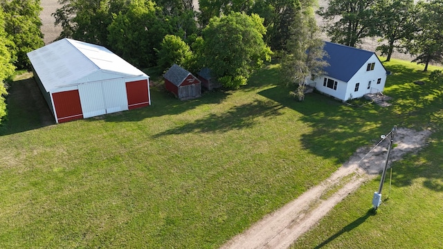 10855 150th St NE, Spicer, MN 56288 - view of green lawn with dirt driveway, an outdoor structure, a pole building, and a detached garage