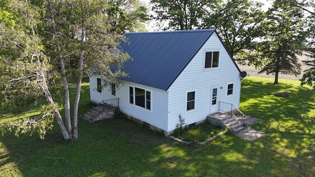 10855 150th St NE, Spicer, MN 56288 - view of side of property featuring a lawn and metal roof