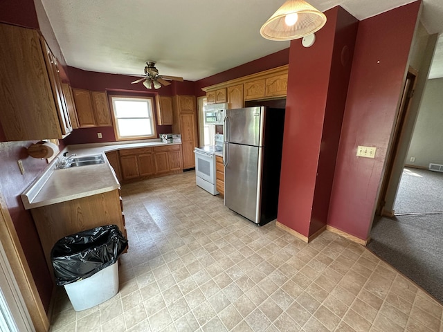 10855 150th St NE, Spicer, MN 56288 - kitchen featuring white appliances, a ceiling fan, a sink, light countertops, and baseboards
