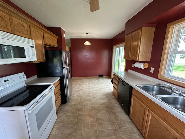 10855 150th St NE, Spicer, MN 56288 - kitchen with white appliances, light countertops, a sink, and brown cabinetry