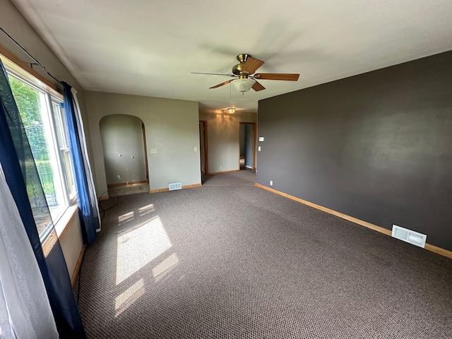 10855 150th St NE, Spicer, MN 56288 - spare room with arched walkways, a ceiling fan, baseboards, and carpet floors
