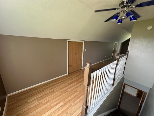 10855 150th St NE, Spicer, MN 56288 - staircase featuring wood finished floors, lofted ceiling, a ceiling fan, and baseboards