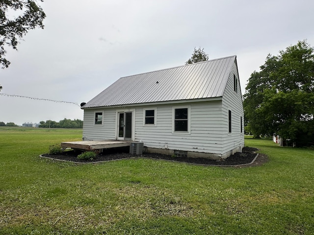 10855 150th St NE, Spicer, MN 56288 - back of property with a yard, a wooden deck, cooling unit, and metal roof
