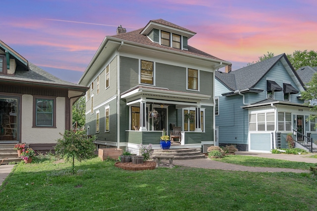 traditional style home with a front lawn, a chimney, and roof with shingles