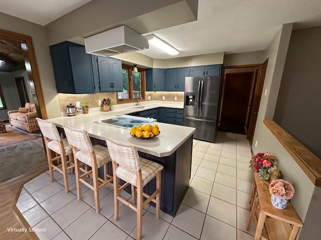 6480 Long Lake Rd, Willmar, MN 56201 - kitchen with stainless steel fridge with ice dispenser, a peninsula, electric stovetop, blue cabinets, and light countertops