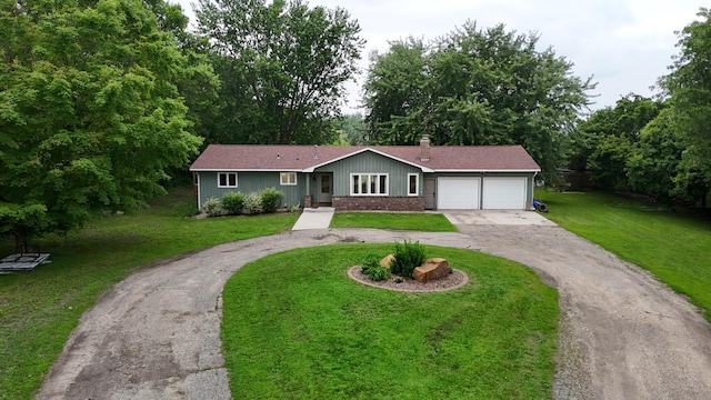 6480 Long Lake Rd, Willmar, MN 56201 - ranch-style home with driveway, a garage, and a front yard