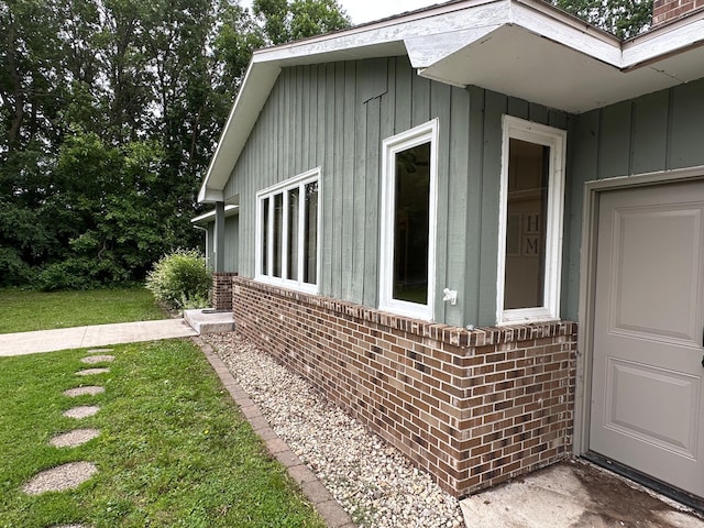 6480 Long Lake Rd, Willmar, MN 56201 - view of home's exterior with board and batten siding, brick siding, and a lawn